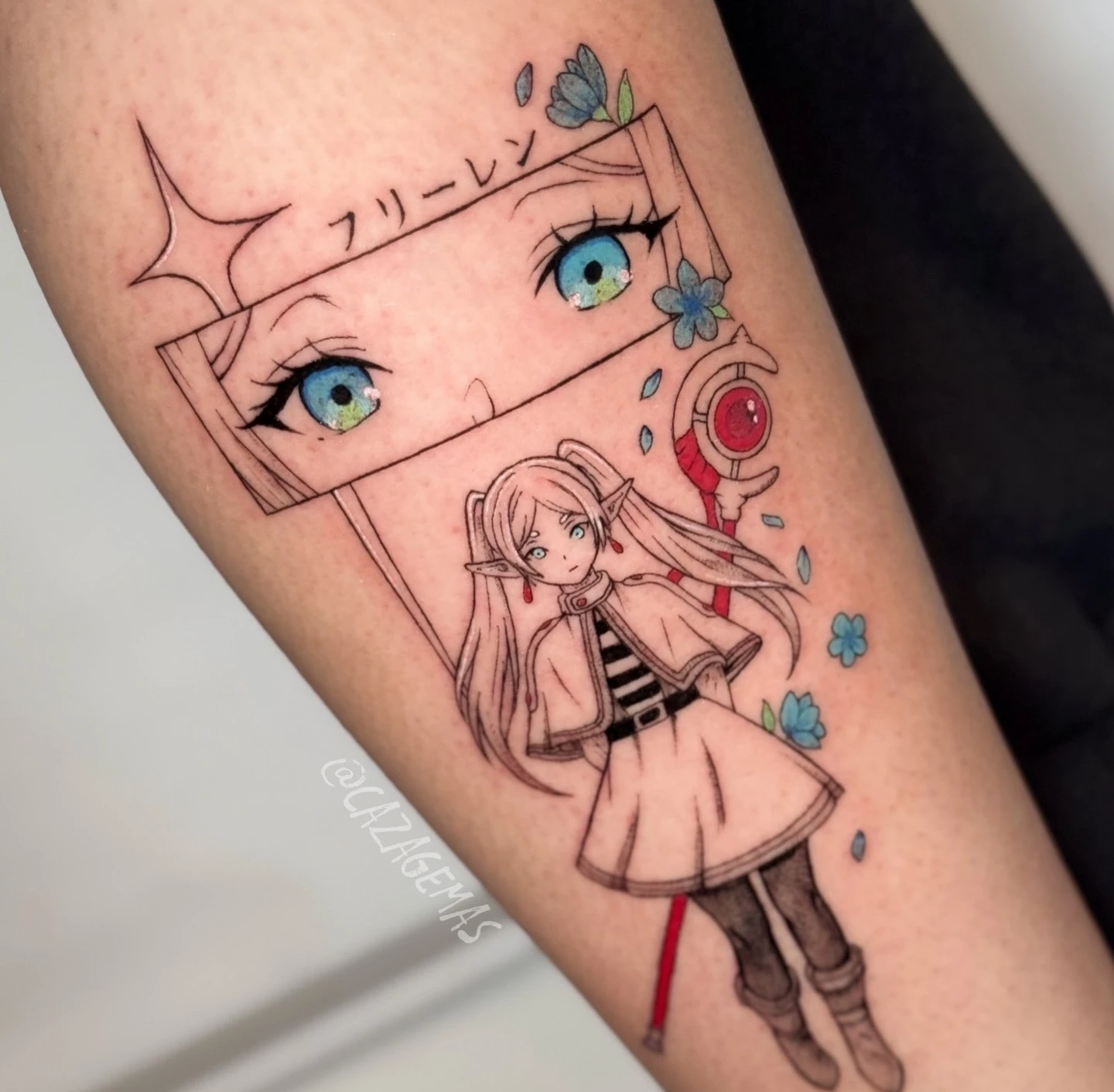 Fine line tattoo of an anime girl with blue eyes and touches of color on the forearm