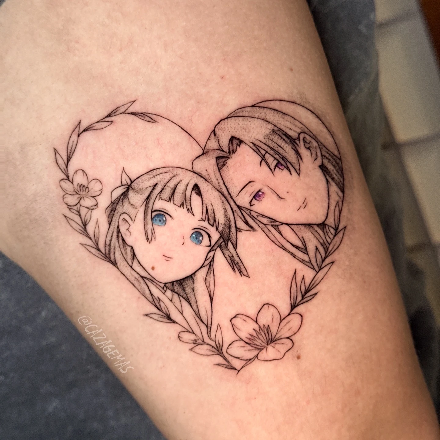 Tattoo of two anime characters embracing inside a heart of flowers
