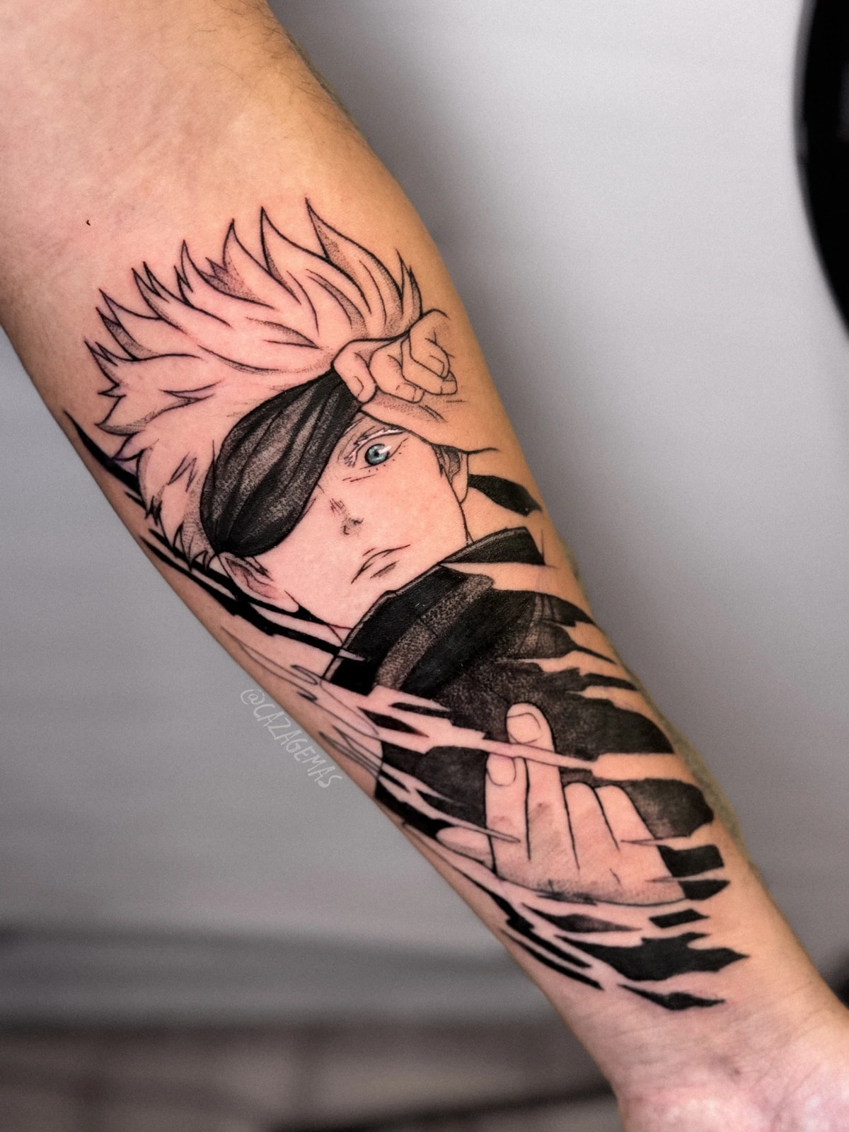 Tattoo of an anime character with an eye patch and a broken-strokes effect