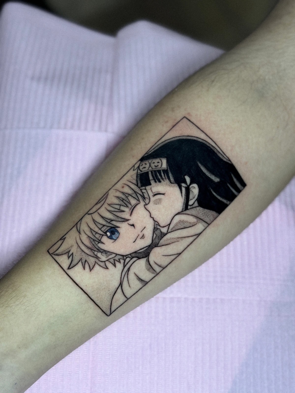 Tattoo of two anime characters in a manga frame