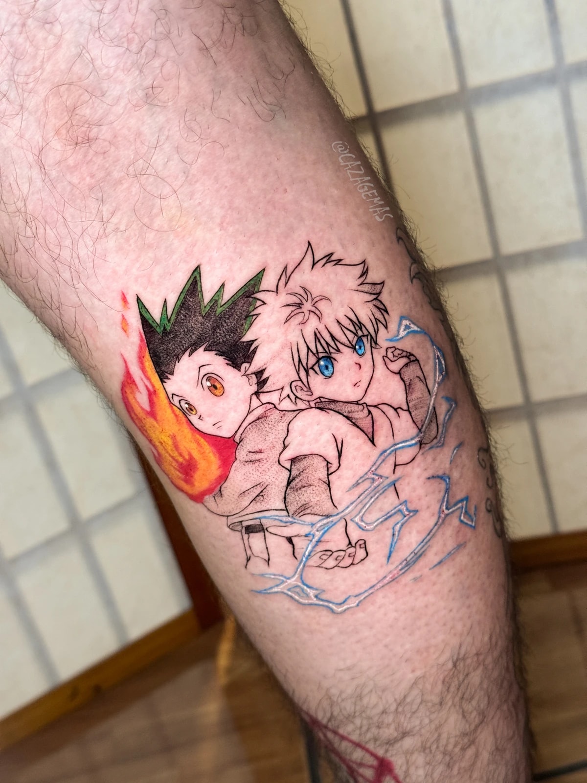 Color fine line tattoo of Gon and Killua from Hunter x Hunter, with fire and lightning